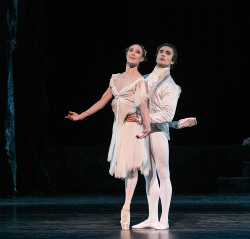 Ballerina på tåspiss med mannlig danser på siden