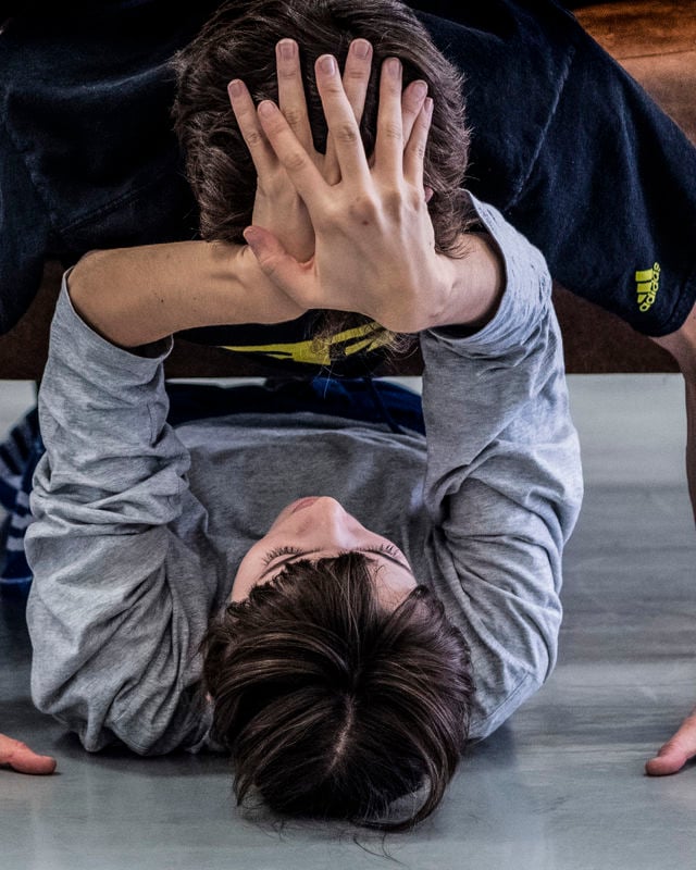 et par danser i studio foran en stor brun sofa