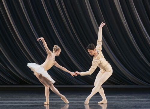 en mann og en dame danser ballett sammen, hun i hvit tutu og tåspissko
