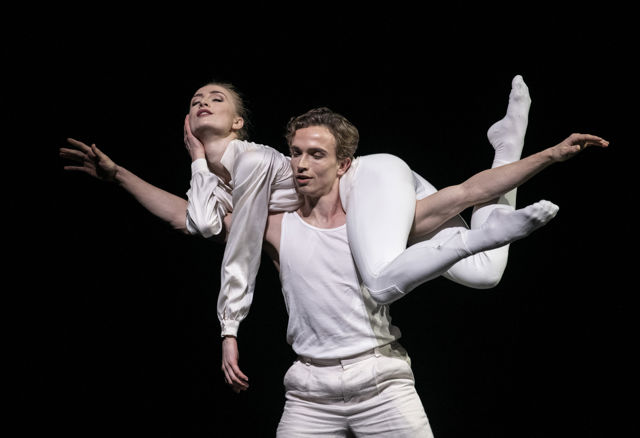 en mann løfter en kvinne og bærer henne over skuldrene